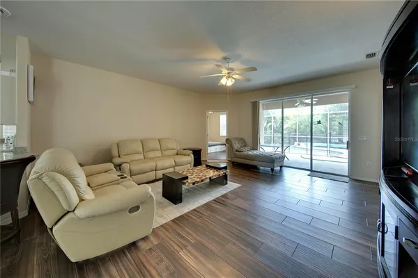 a living room with fireplace furniture and a flat screen tv