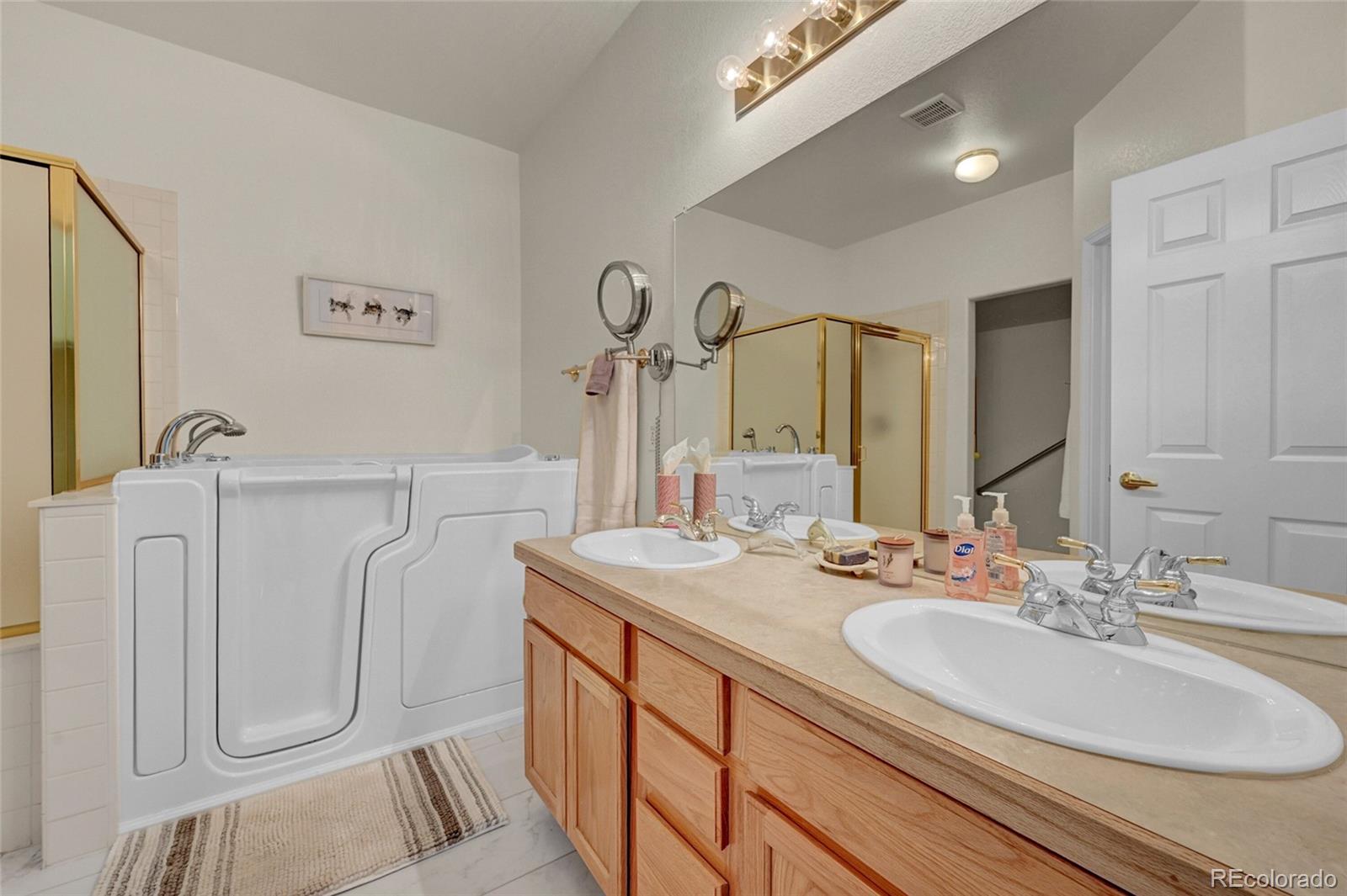 6687 South Reed Way, Unit A Littleton, CO 80123 - Photo 15 of 31 a bathroom with a double vanity sink and a mirror