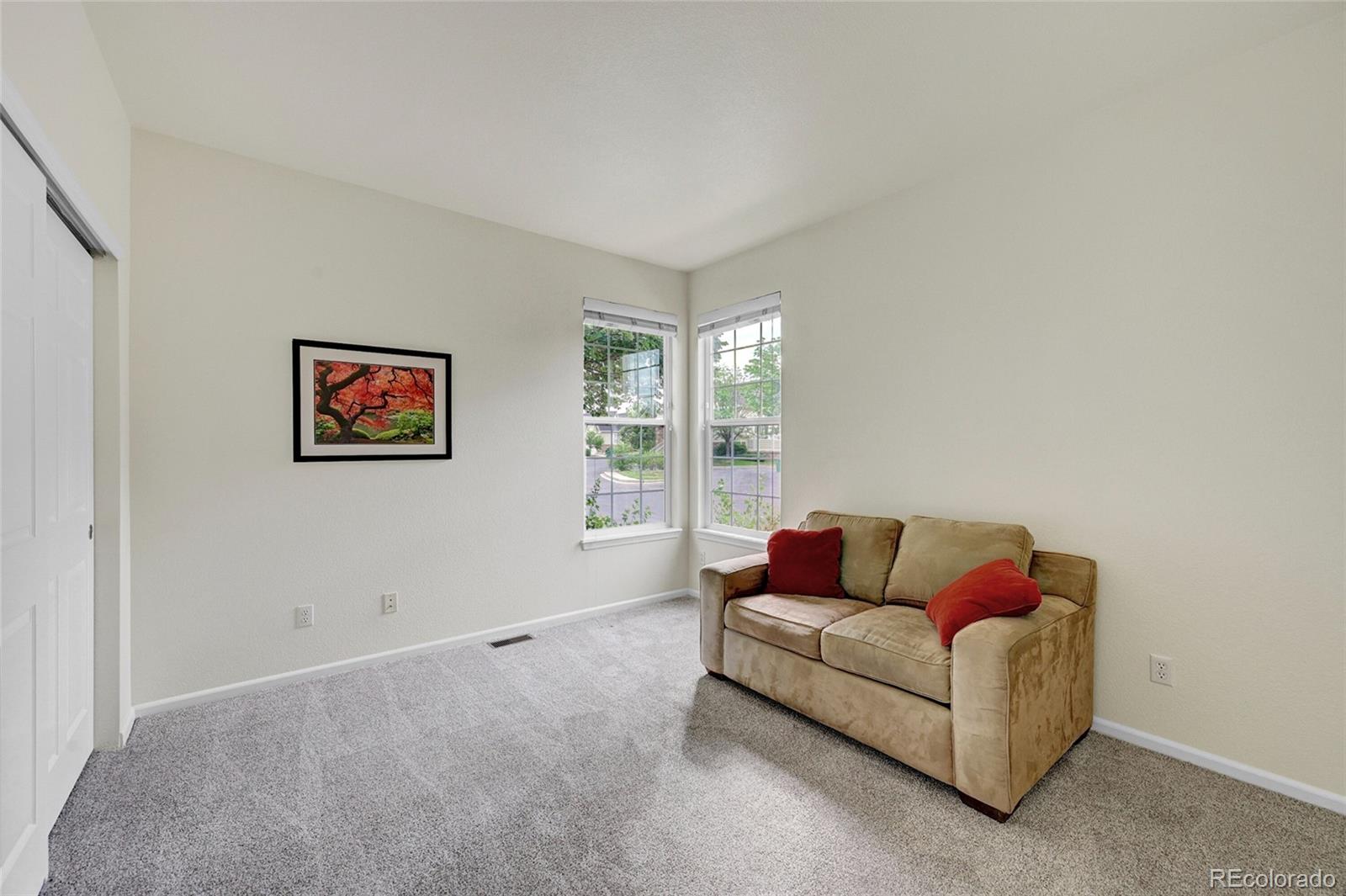 6687 South Reed Way, Unit A Littleton, CO 80123 - Photo 18 of 31 a living room with furniture and a window