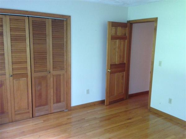 381 East County Road Rutland, MA 01543 - Photo 11 of 28 an empty room with wooden floor and closet