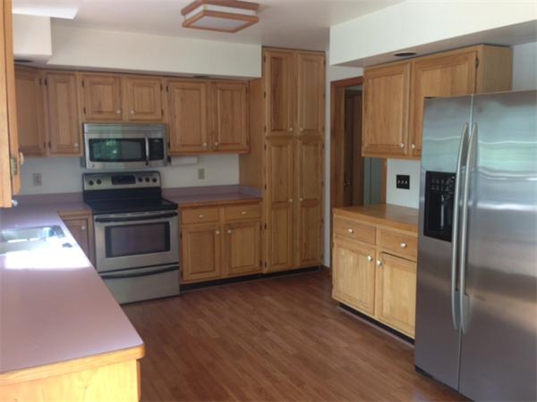 381 East County Road Rutland, MA 01543 - Photo 2 of 28 a kitchen with wooden cabinets and stainless steel appliances