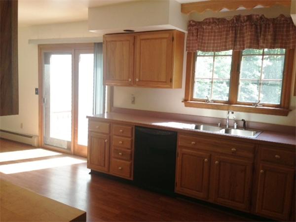 381 East County Road Rutland, MA 01543 - Photo 3 of 28 a kitchen with stainless steel appliances granite countertop wooden cabinets a sink and a window
