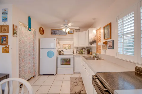 a kitchen with a refrigerator a stove a sink and a cabinets