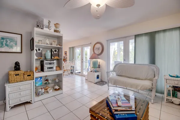 a living room with furniture and a baby crib