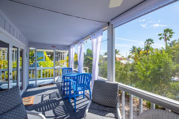 a view of a two chairs in the balcony