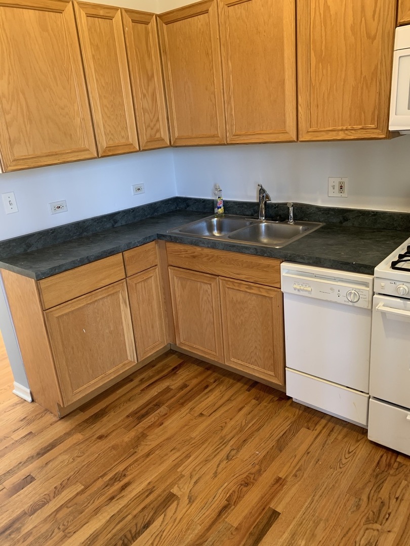 a view of a kitchen with wooden floor