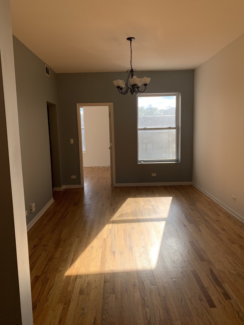 Undisclosed Address Chicago, IL 60637 - Photo 11 of 16 a view of empty room with wooden floor and fan