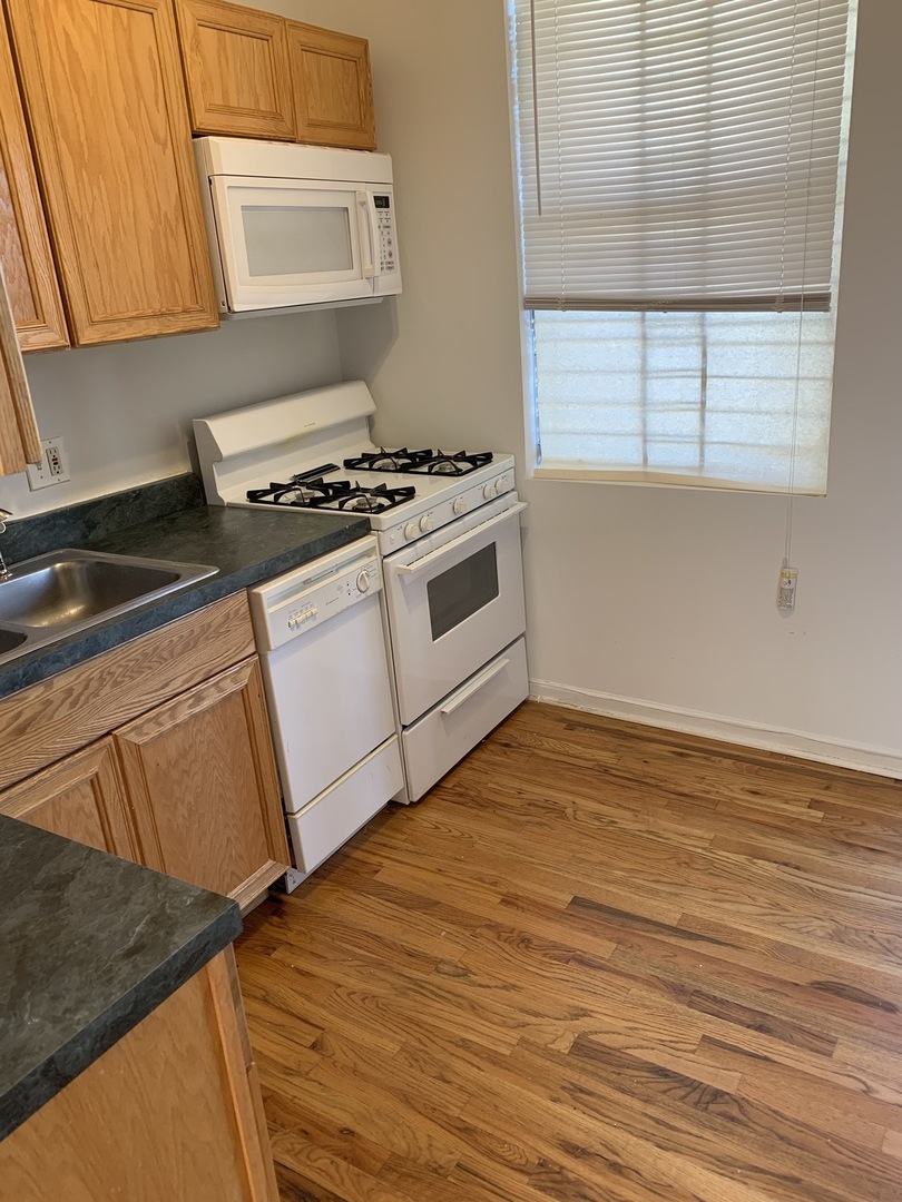 Undisclosed Address Chicago, IL 60637 - Photo 2 of 16 a kitchen with granite countertop a stove and a microwave