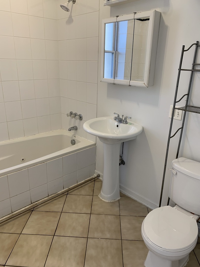 Undisclosed Address Chicago, IL 60637 - Photo 7 of 16 a bathroom with a sink toilet and shower