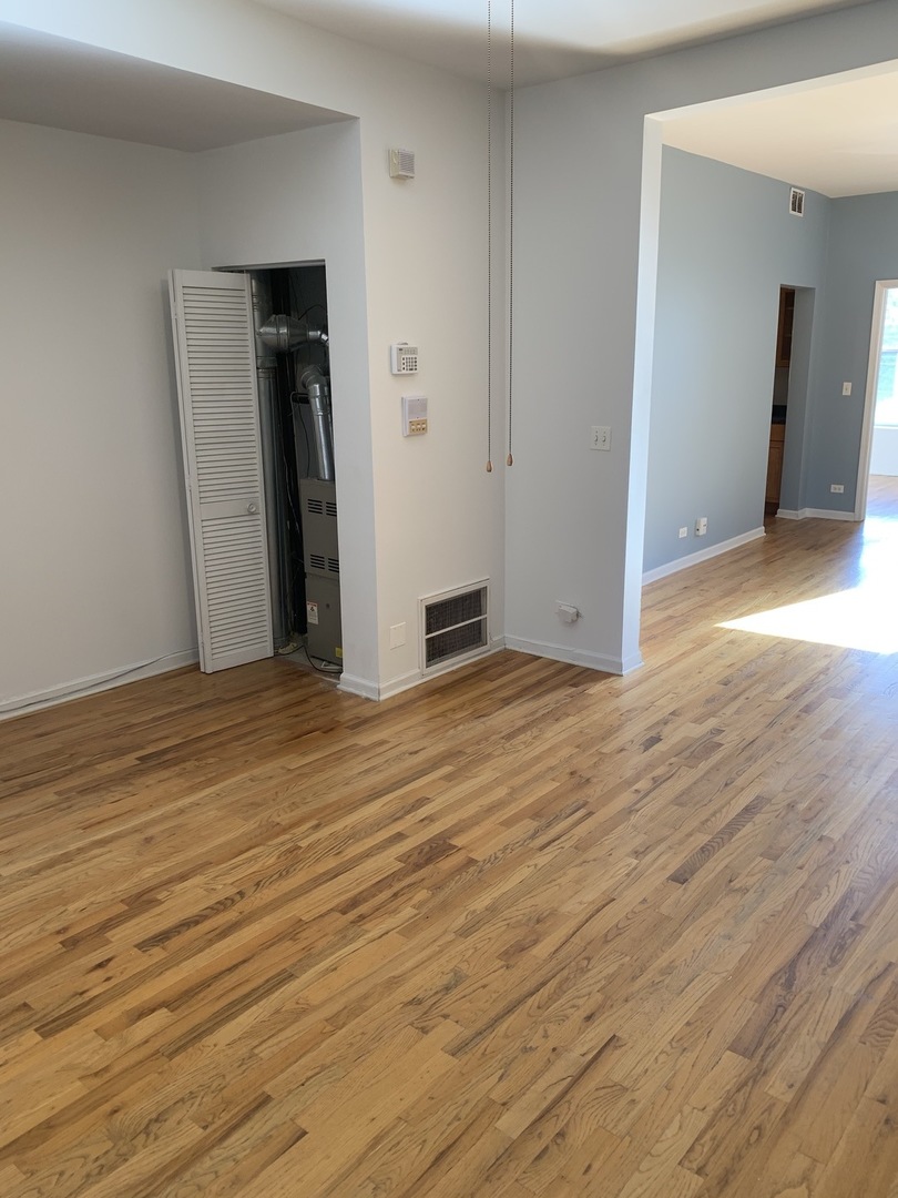 Undisclosed Address Chicago, IL 60637 - Photo 9 of 16 a view of an empty room with wooden floor