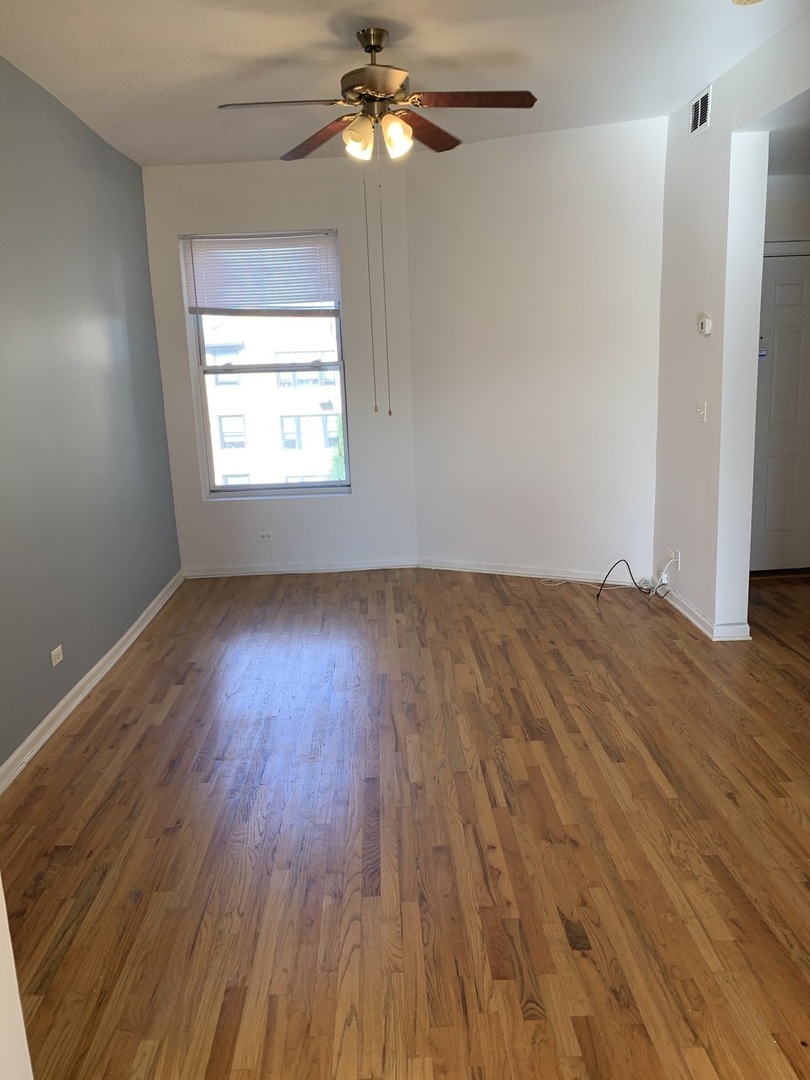 Undisclosed Address Chicago, IL 60637 - Photo 10 of 16 a view of empty room with wooden floor and fan