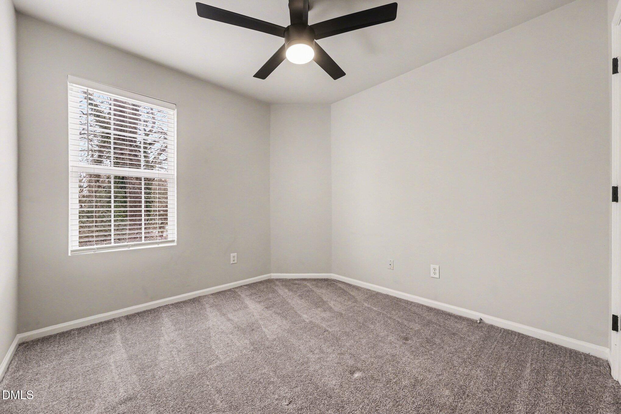 702 Brye Street Durham, NC 27703 - Photo 16 of 32 an empty room with a window and a fan