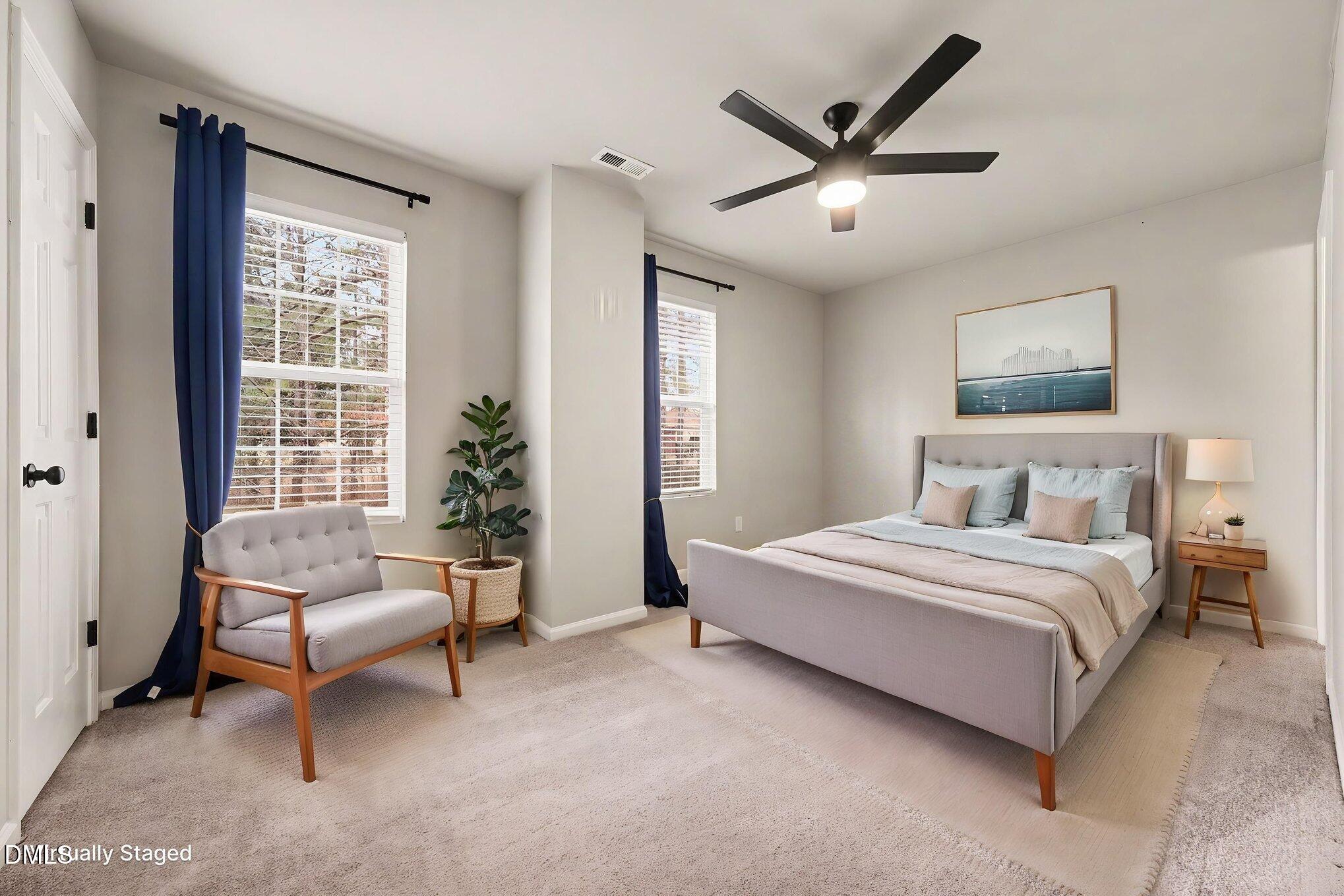 702 Brye Street Durham, NC 27703 - Photo 22 of 32 a spacious bedroom with a bed and a couch