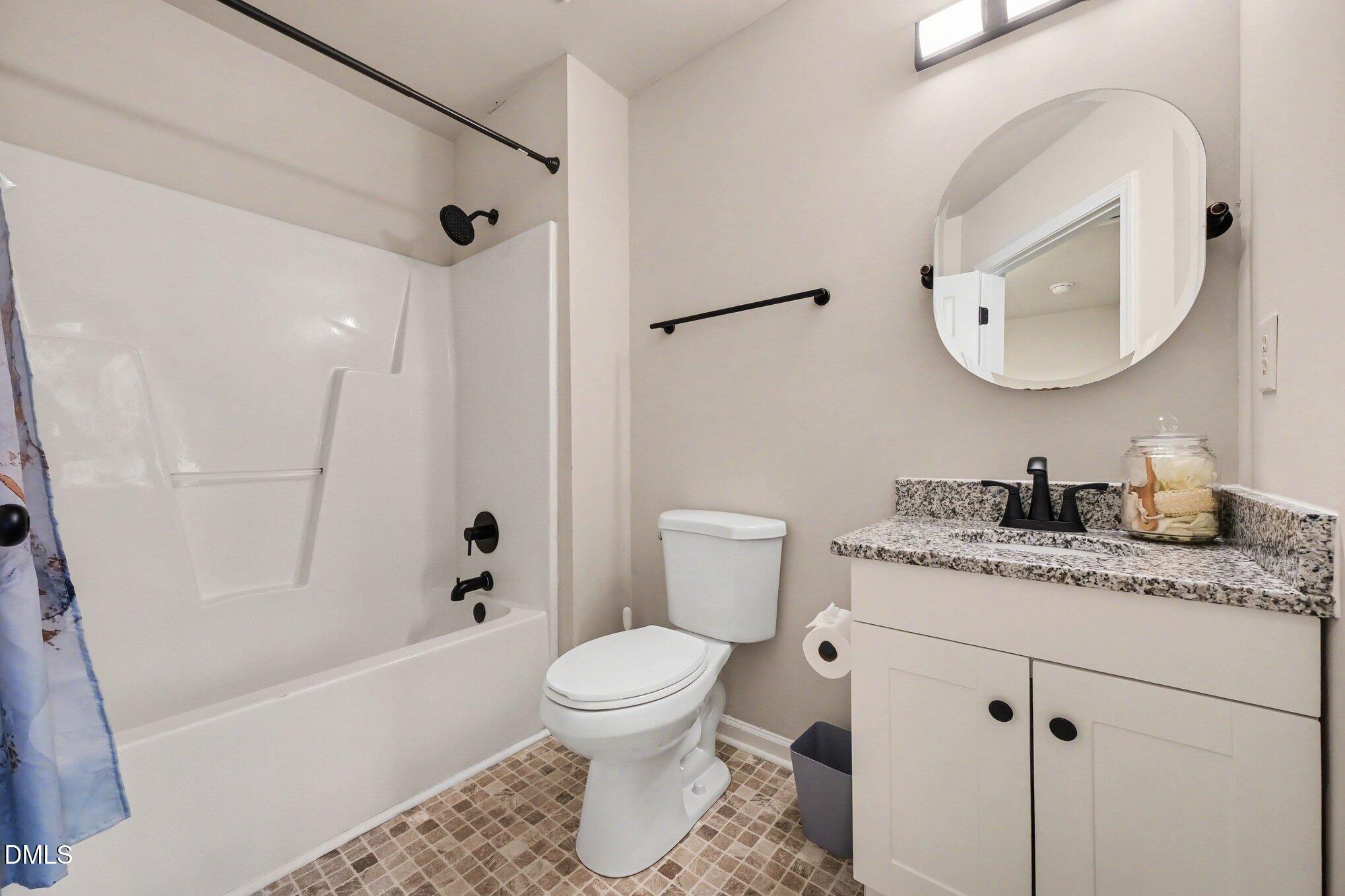 702 Brye Street Durham, NC 27703 - Photo 25 of 32 a bathroom with a granite countertop sink toilet and shower