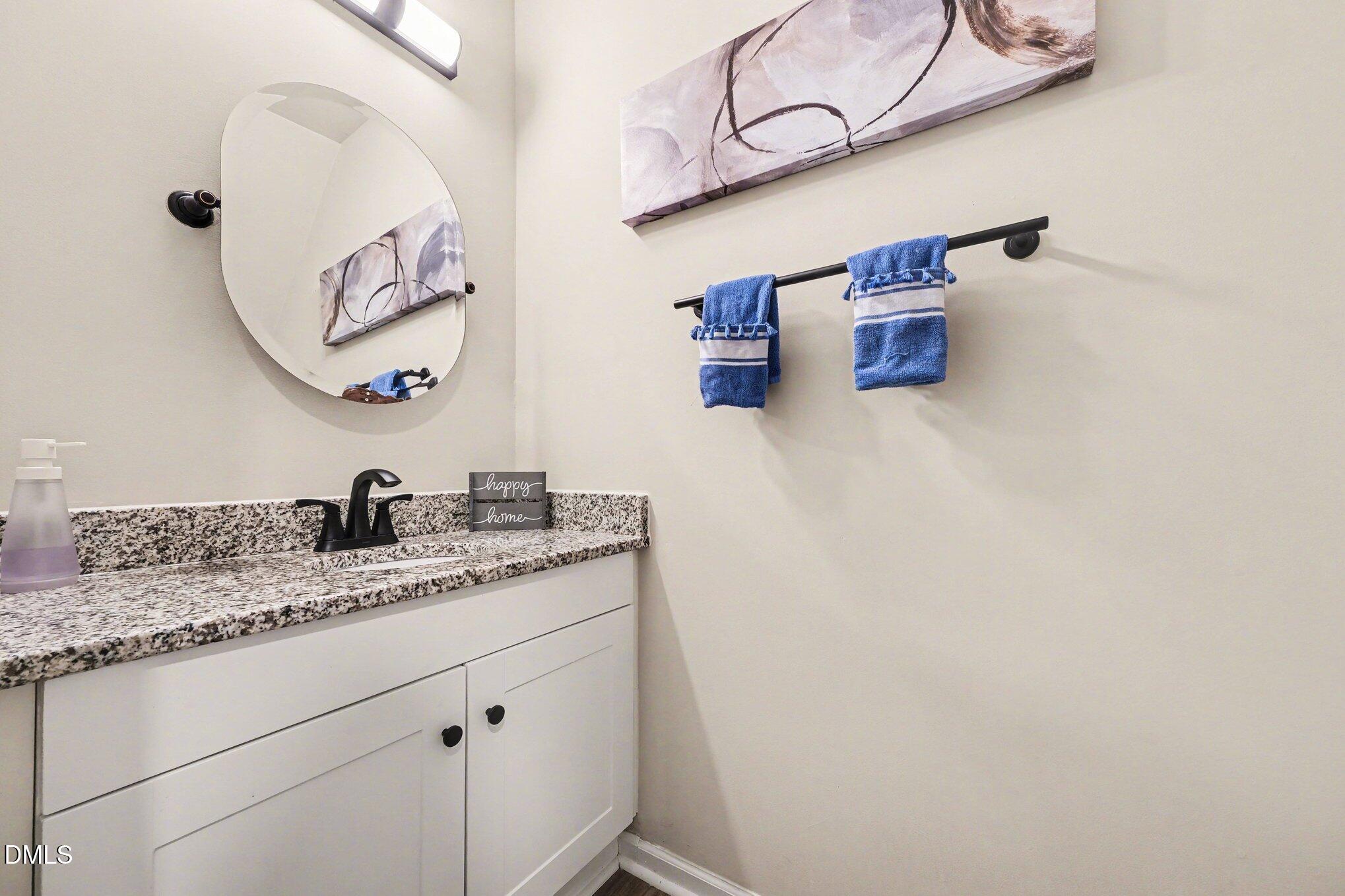 702 Brye Street Durham, NC 27703 - Photo 8 of 32 a bathroom with a granite countertop sink and a mirror