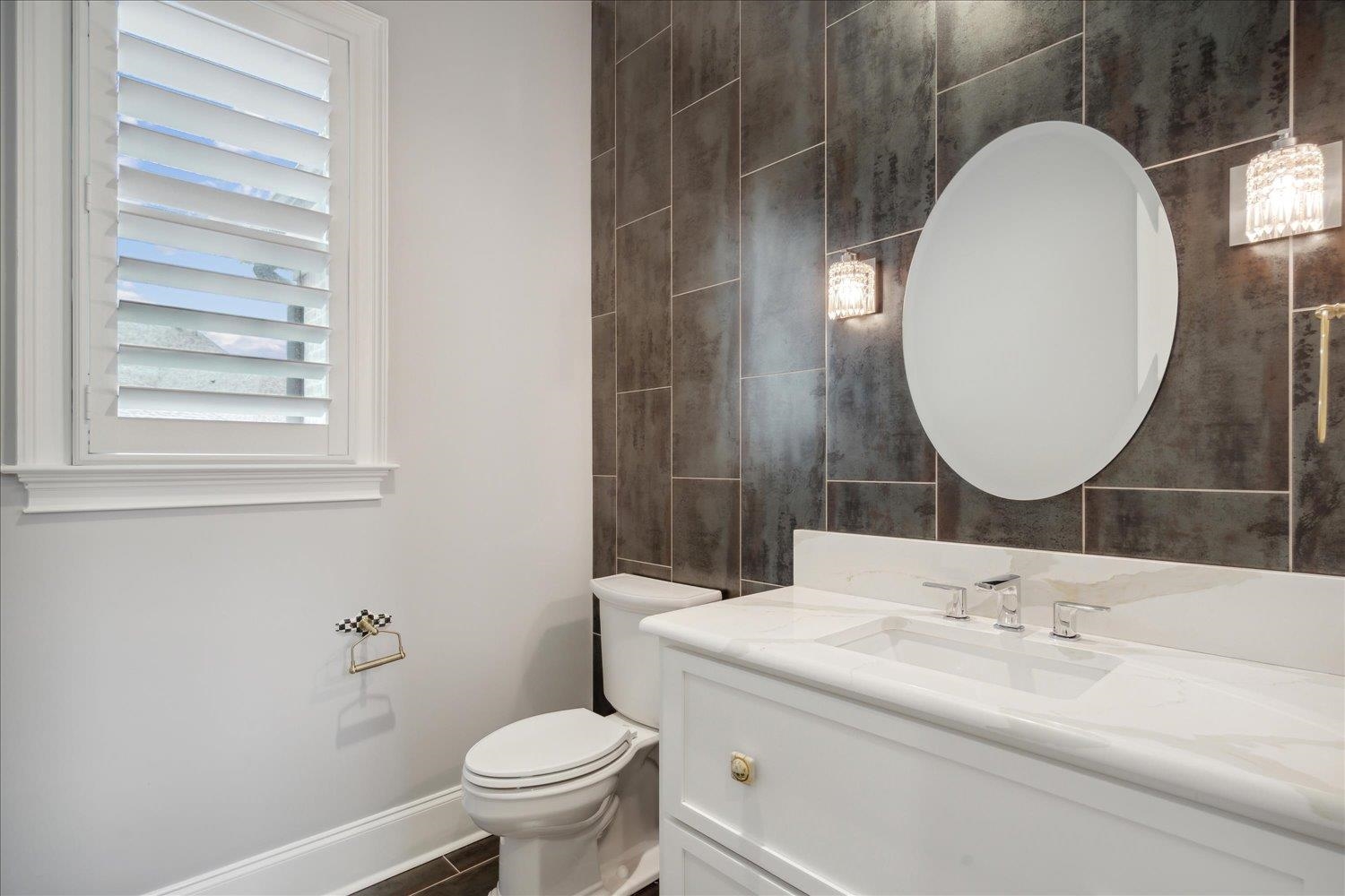 1676 Exeter Road Germantown, TN 38138 - Photo 16 of 38 a bathroom with a sink and a mirror