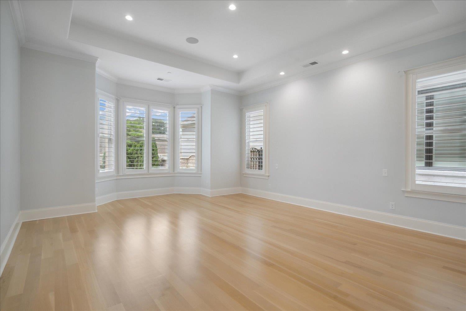 1676 Exeter Road Germantown, TN 38138 - Photo 18 of 38 an empty room with wooden floor and windows