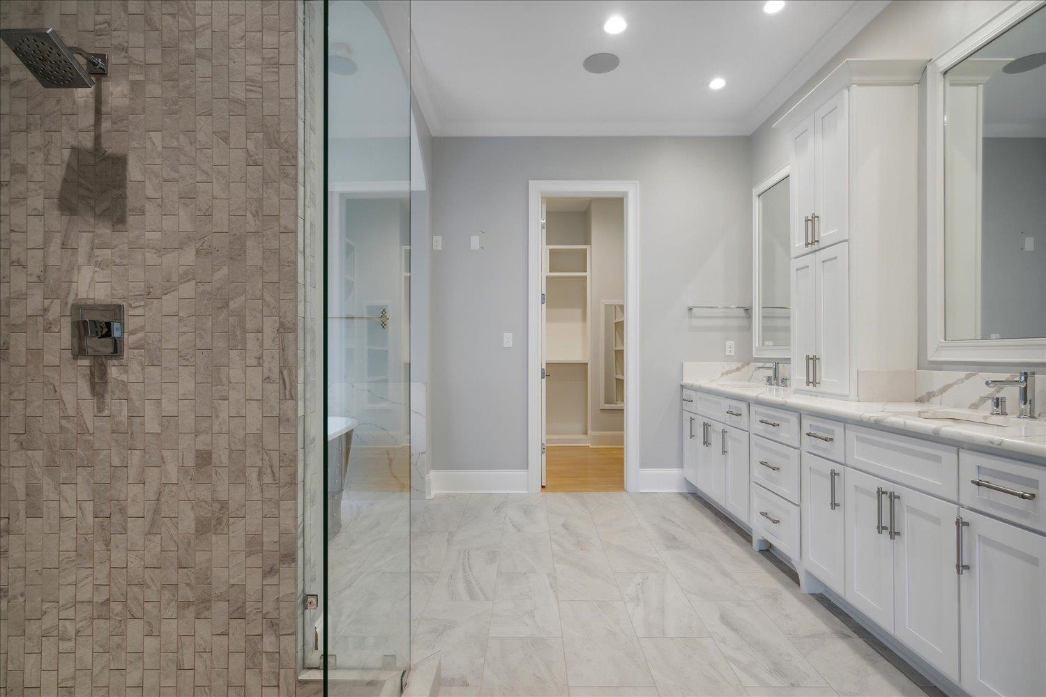 1676 Exeter Road Germantown, TN 38138 - Photo 19 of 38 a bathroom with a double vanity sink a large mirror and a shower
