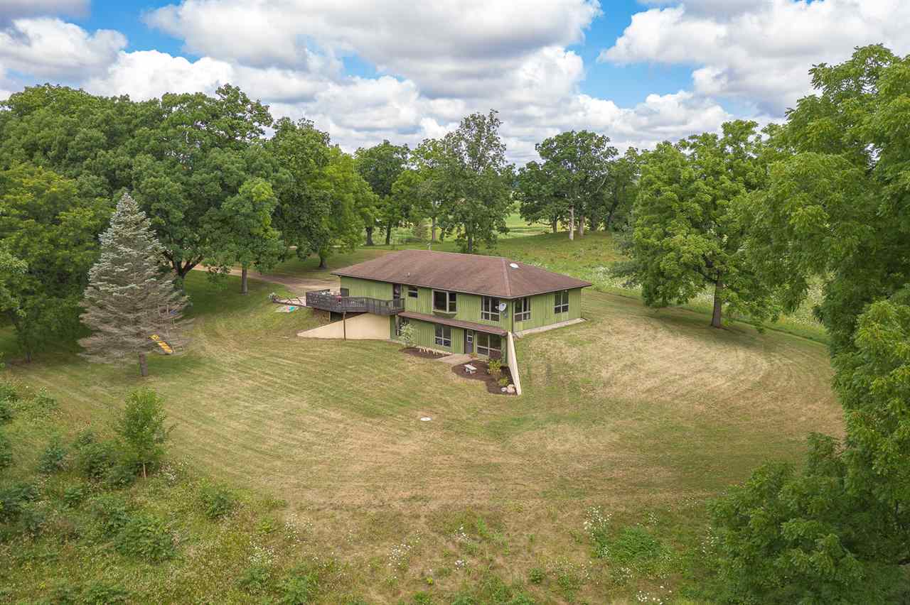 1783 West Pines Road Oregon, IL 61061 - Photo 1 of 24 a backyard of a house with table and chairs