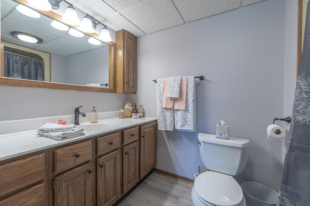 1783 West Pines Road Oregon, IL 61061 - Photo 13 of 24 a bathroom with a granite countertop toilet sink and mirror