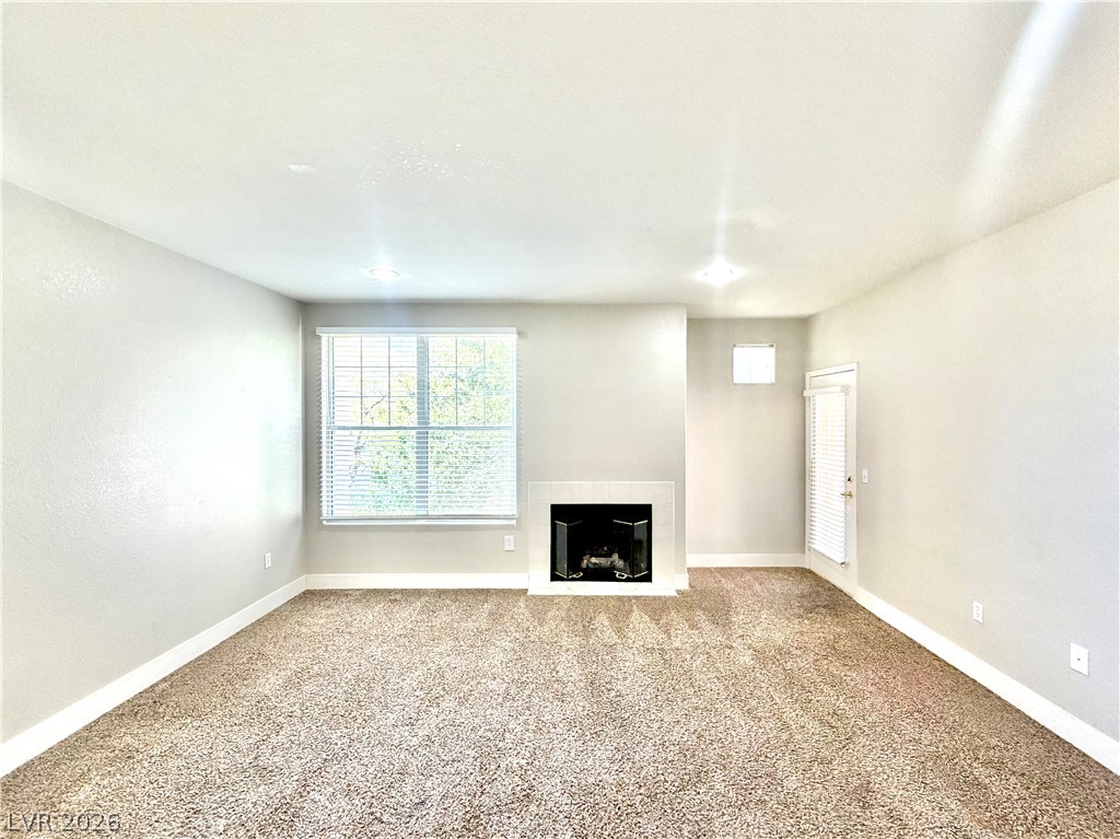 8555 West Russell Road, Unit 2018 Las Vegas, NV 89113 - Photo 13 of 23 A cozy living space features an elegant fireplace, ready for relaxing evenings.
