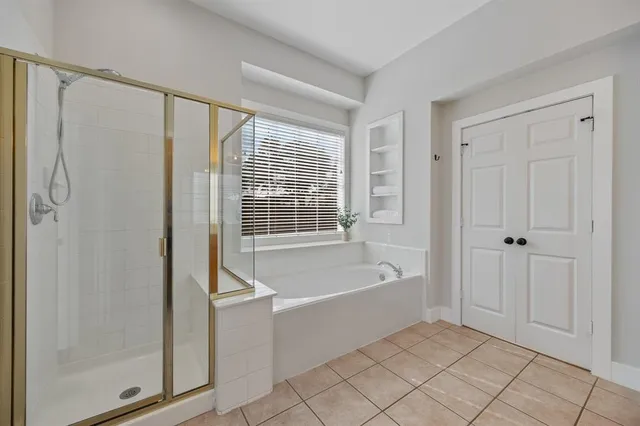 a spacious bathroom with a bathtub and a shower