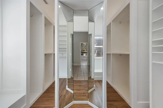 a bathroom with a glass shower door and a mirror