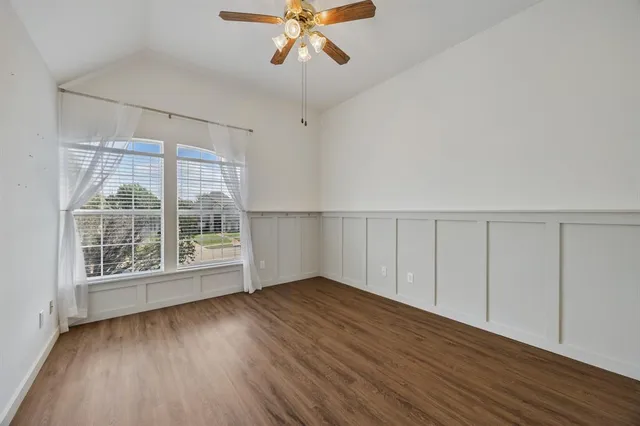 wooden floor in an empty room with a window