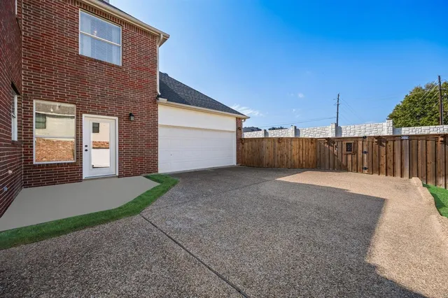 a view of a house with a backyard and garage