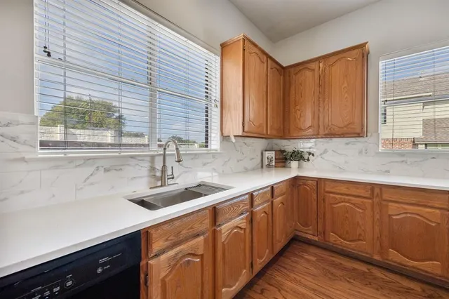 a kitchen with a sink cabinets and window