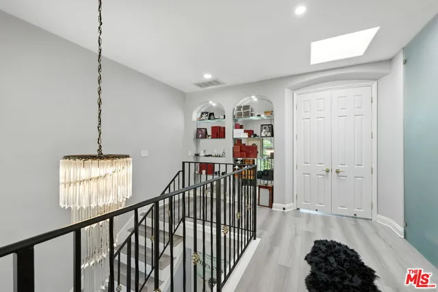 a view of a hallway with a window and stairs