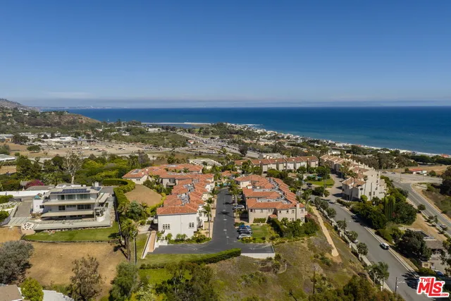an aerial view of residential building and ocean view