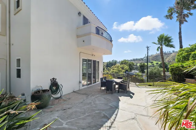 a view of a patio with couches and potted plants