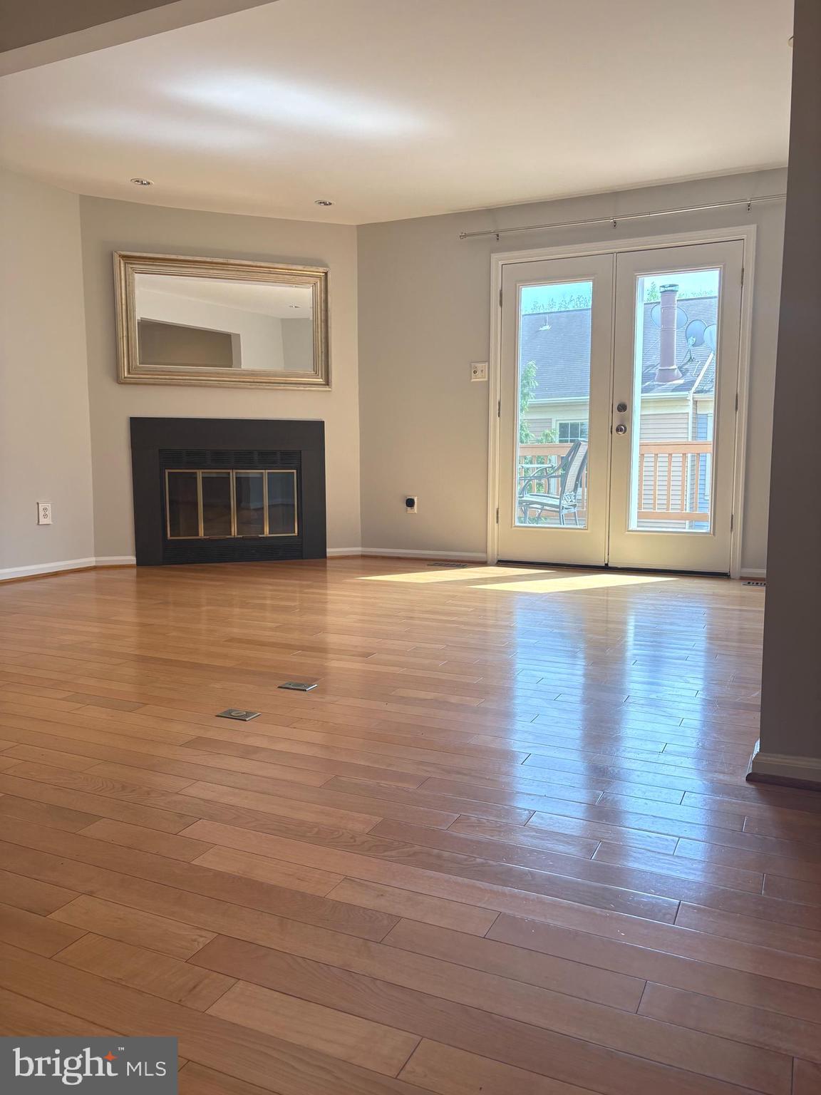 35 Grove Ridge Court, Unit 80 Rockville, MD 20852 - Photo 2 of 6 a view of an empty room with wooden floor and a window