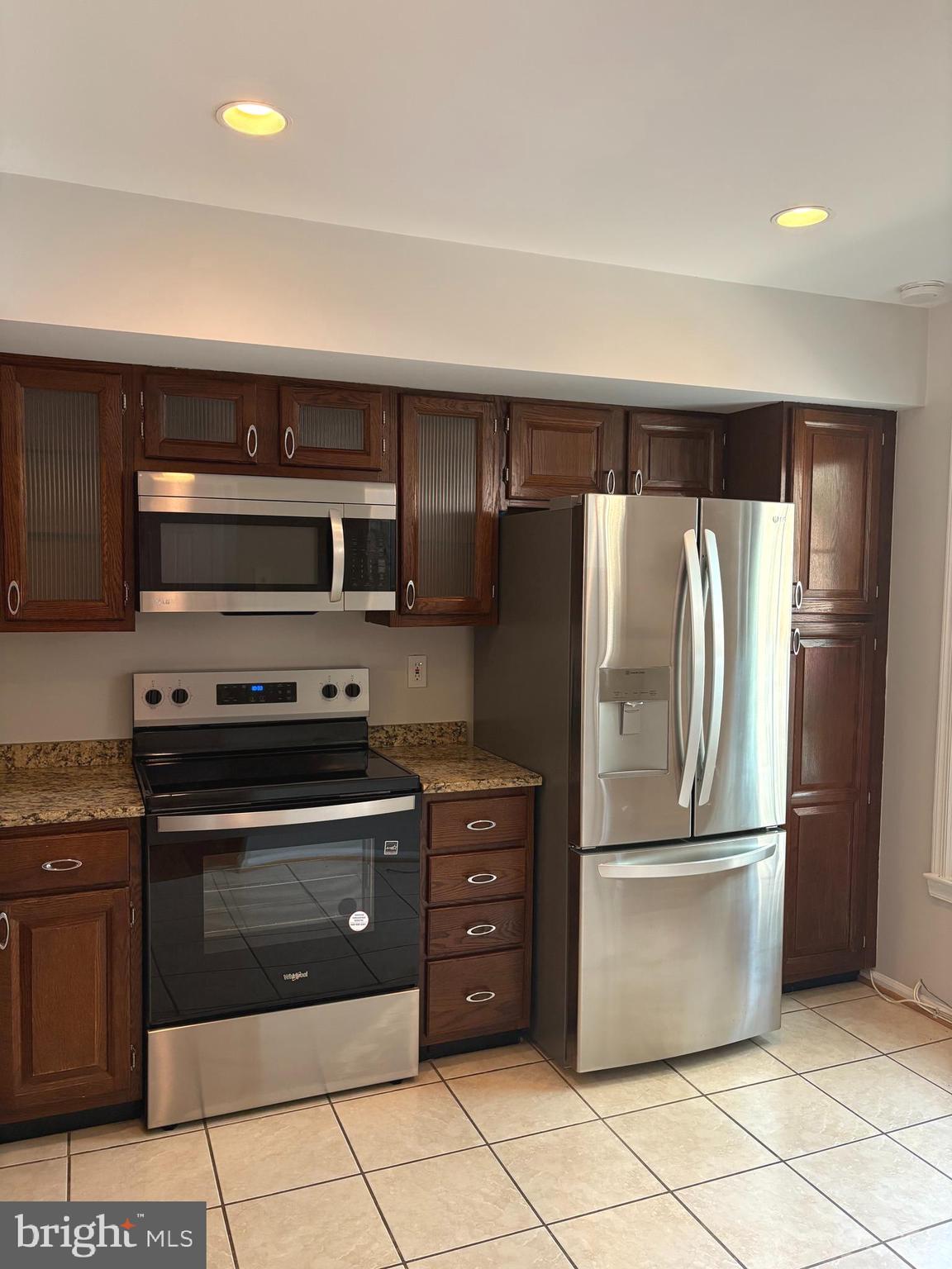 35 Grove Ridge Court, Unit 80 Rockville, MD 20852 - Photo 3 of 6 a kitchen with stainless steel appliances granite countertop a refrigerator and a stove top oven