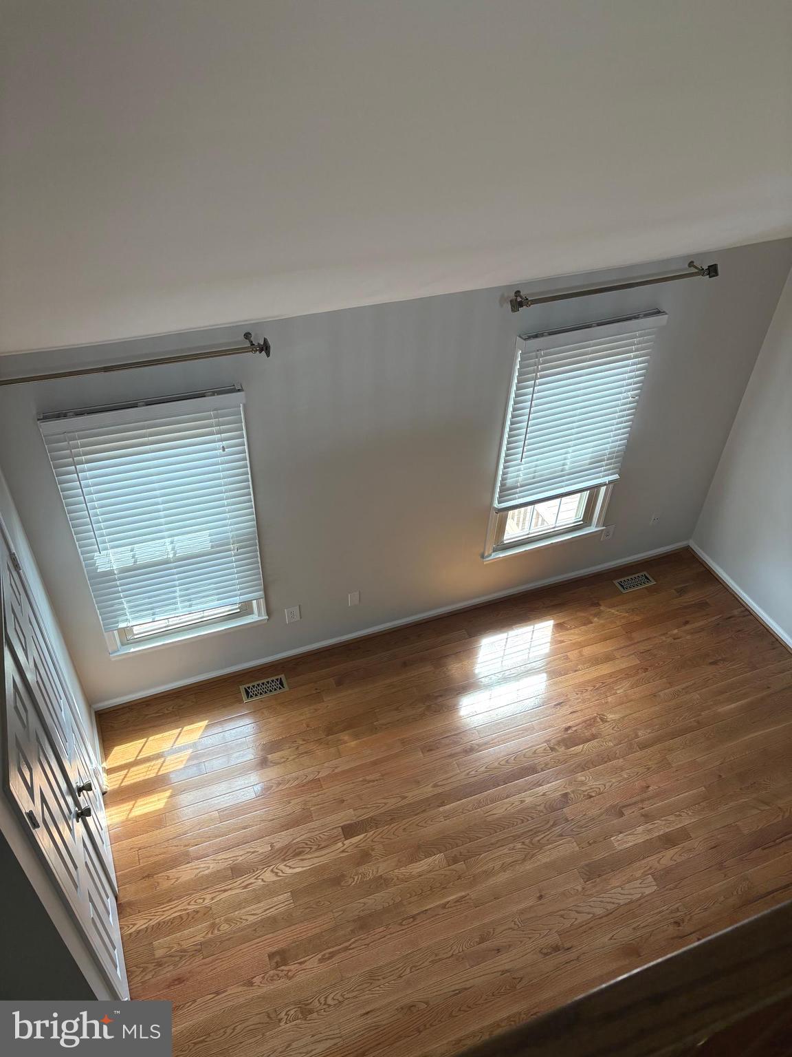 35 Grove Ridge Court, Unit 80 Rockville, MD 20852 - Photo 5 of 6 an empty room with wooden floor and windows