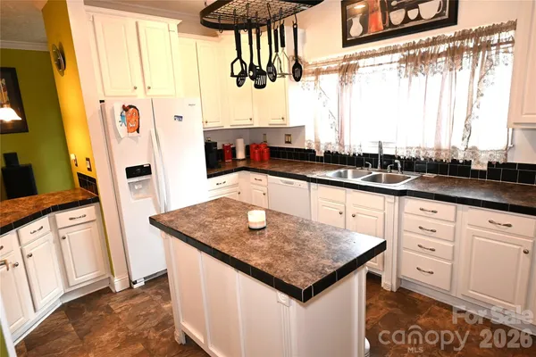 a kitchen with stainless steel appliances granite countertop a sink and a cabinets