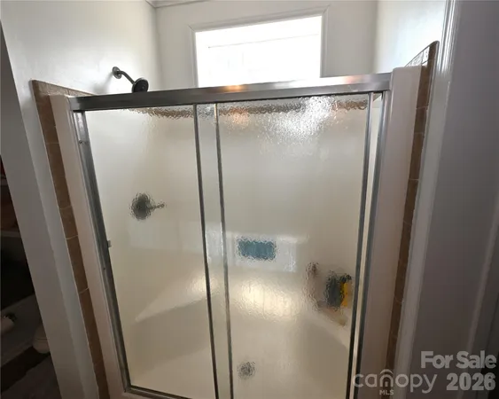 a bathroom with a glass shower door