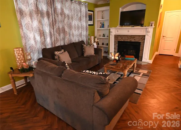 a living room with furniture and a fireplace
