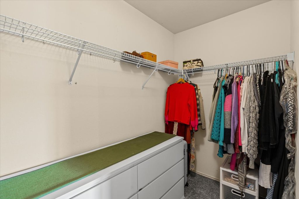 12209 Briarcreek Loop Manor, TX 78653 - Photo 15 of 23 a view of walk in closet with clothes and shoes
