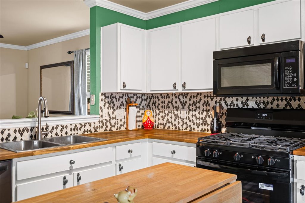 12209 Briarcreek Loop Manor, TX 78653 - Photo 7 of 23 a kitchen with stainless steel appliances a stove and a microwave