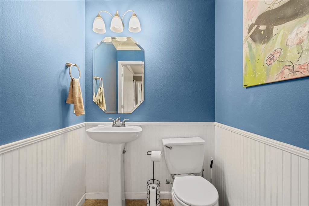12209 Briarcreek Loop Manor, TX 78653 - Photo 10 of 23 a bathroom with a toilet sink and mirror