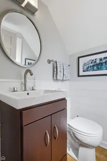 a bathroom with a toilet sink and mirror