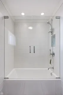 a bathroom with a shower and a bath tub