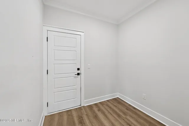 a view of a room with wooden floor and bathroom