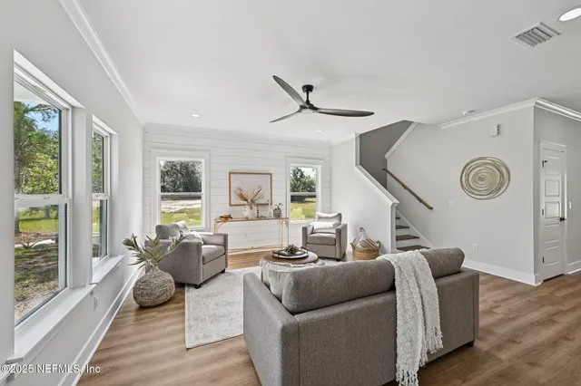 a living room with furniture and a clock