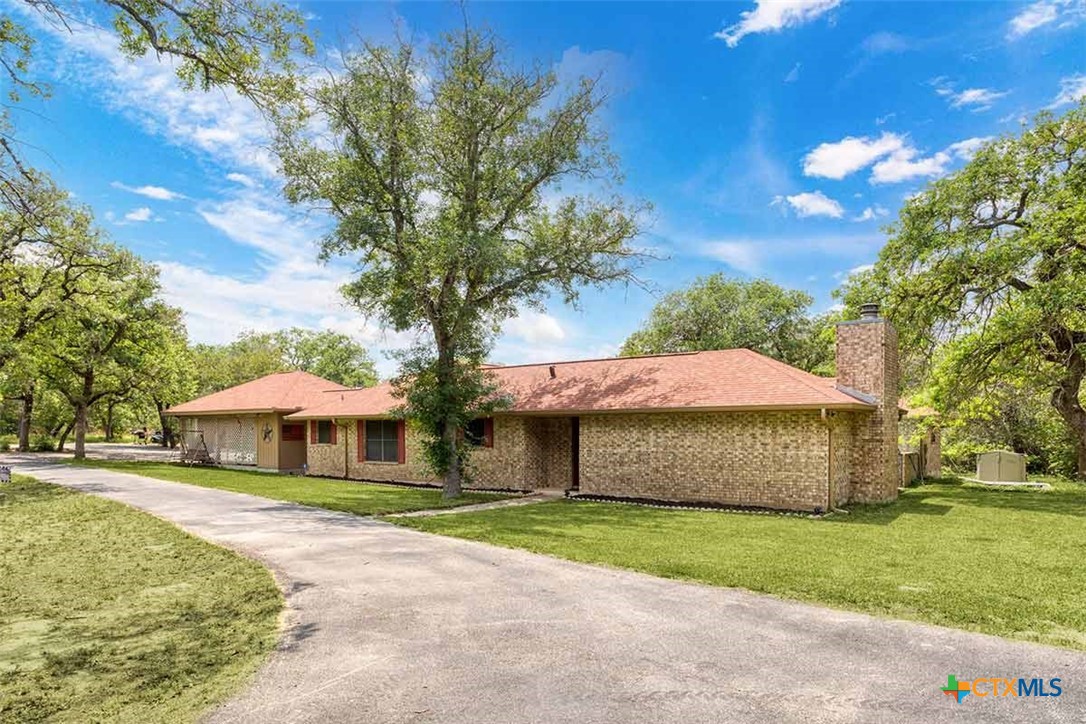 20-acres Guadalupe Ranch Lane Seguin, TX 78155 - Photo 11 of 42 a front view of a house with a garden and tree