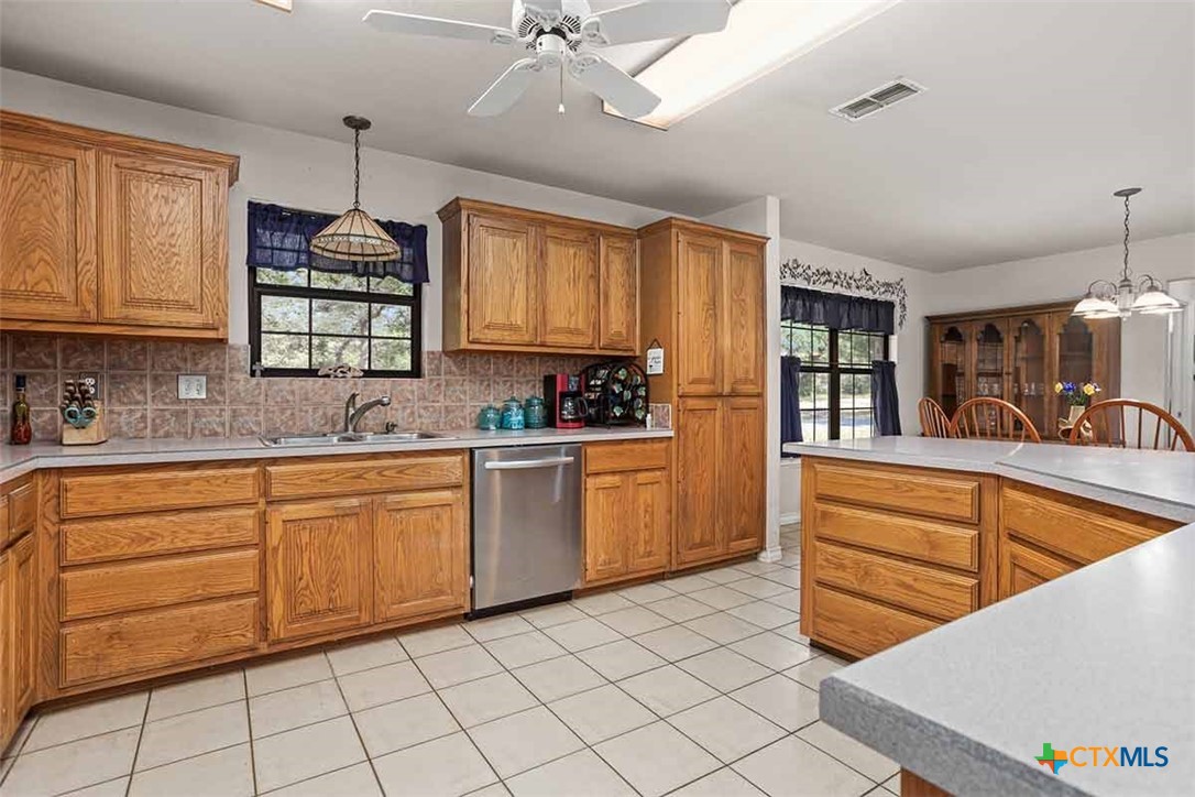 20-acres Guadalupe Ranch Lane Seguin, TX 78155 - Photo 19 of 42 a kitchen with granite countertop a sink window and cabinets