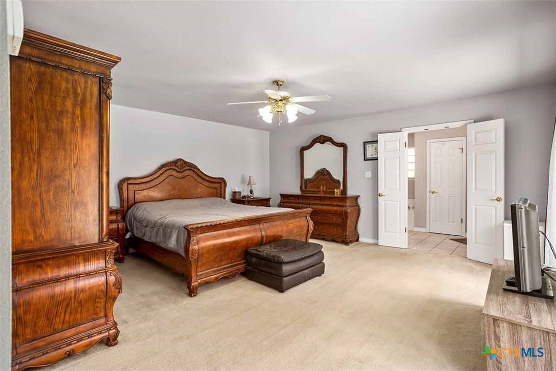20-acres Guadalupe Ranch Lane Seguin, TX 78155 - Photo 32 of 42 a bedroom with a bed and a chandelier