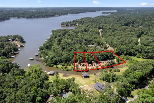 an aerial view of a house with a yard and lake view